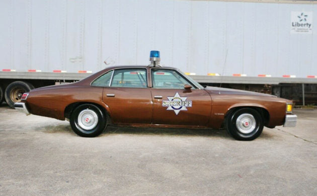 86*523 license plate on Sheriff Buford T Justice's bronze 1977 Pontiac LeMans 