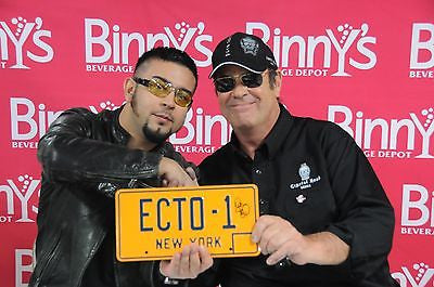 Dan Aykroyd with ECTO-1 plate from Ghostbusters